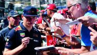 Red Bull's Dutch driver Max Verstappen signs autographs to F1 fans during an autograph session at the pit lane of the Monaco street circuit on May 25, 2018 in Monaco, ahead of the Monaco Formula 1 Grand Prix. AFP / Andrej Isakovic