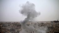 Smoke rises from buildings in a rebel-held neighbourhood of Daraa in southern Syria following reported shelling by the regime on May 22, 2018. / AFP / Mohamad ABAZEED
