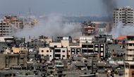A picture taken from Gaza City on May 29, 2018, shows a smoke billowing in the background following an Israeli air strike on the Palestinian enclave.  / AFP / THOMAS COEX 