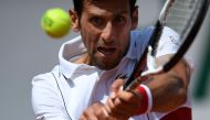 Serbia's Novak Djokovic plays a backhand return to Spain's Jaume Munar during their men's singles second round match on day four of The Roland Garros 2018 French Open tennis tournament in Paris on May 30, 2018. / AFP / CHRISTOPHE SIMON