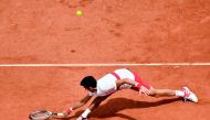 Novak Djokovic plays a backhand return to Spain's Jaume Munar during their men's singles second round match on day four of The Roland Garros 2018 French Open tennis tournament in Paris on May 30, 2018. AFP / Christophe Simon