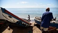 A fisherman works next to a boat in Cap-Haitien, Haiti on September 6, 2017 ,240kms north of Port-au-Prince (AFP / Hector Retamal) 