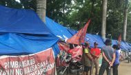 Activists and farmers demanding land stand at their camp outside the provincial agriculture office in Tagum City, Philippines. March 21, 2018. Thomson Reuters Foundation/Rina Chandran