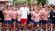 Novak Djokovic running with Ball boys and girls. Reuters/Benoit Tessier 