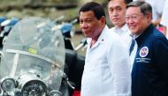 Philippine President Rodrigo Duterte (L) attends a ceremony where seized vehicles and motorcycles were destroyed at the customs yard in Manila on May 30, 2018. AFP / Ted Aljibe