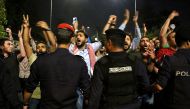 Demonstrators confront anti-riot policemen as they protest against against a proposed income tax draft law in front of the Prime Minister's office in Amman, late on June 1, 2018.   AFP / STRINGER
