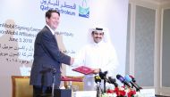 Saad Sherida Al Kaabi, President and CEO of Qatar Petroleum, and Andrew P Swiger, Senior Vice-President and Principal Financial Officer of ExxonMobil Corporation, exchanging the signed documents in Doha yesterday. Pic: Baher Amin / The Peninsula