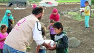 Qatar Charity volunteers distributing iftar meals.