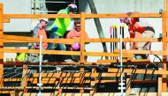 Workers lay concrete at the construction of a new apartment block in Melbourne on June 5, 2018. Australia's central bank kept interest rates at a record low on June 5 for a 20th consecutive meeting as it waits for unemployment to fall further and signs of