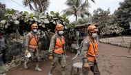 Soldiers inspect an area affected by the eruption of the Fuego volcano in the community of San Miguel Los Lotes in Escuintla, Guatemala June 5, 2018. REUTERS/Luis Echeverria