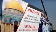 A picture taken on June 5, 2018, shows a poster erected on a main street in the West Bank town of Hebron, denouncing the upcoming friendly football match between Argentina and Israel and calling Argentina's star Lionel Messi (portrait) to boycott the matc