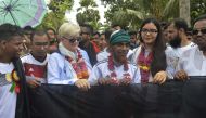 Amjad Hossain (C), Bangladeshi farmer who made a large German flag, gesturing as he unfurls the flag in Magura on June 5, 2018. AFP