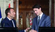 Canadian Prime Minister Justin Trudeau (R) and French President Emmanuel Macron (L)shake hands during a joint press conference at Parliament on June 7, 2018 in Ottawa. Macron and Canadian Prime Minister Justin Trudeau expressed support for 