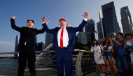 Howard, an Australian-Chinese impersonating North Korean leader Kim Jong-un, and Dennis Alan, impersonating U.S. President Donald Trump, meet at Merlion Park in Singapore June 8, 2018. REUTERS/Edgar Su