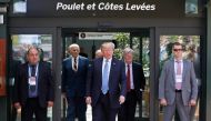 U.S. President Donald Trump speaks while in front of a restaurant sign that reads 