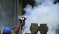 An anti-government demonstrator fires a home-made mortar during clashes with riot police at a barricade in the town of Masaya, 35 km from Managua on June 9, 2018. AFP / INTI OCON