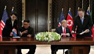 Kim Yo Jong shows a document to her brother, North Korea's leader Kim Jong Un as U.S. Secretary of State Mike Pompeo shows a copy of it to President Donald Trump before they sign them at their summit at the Capella Hotel on Sentosa island in Singapore Jun