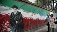 People past a mural painted on the wall of the former US Embassy in Tehran, Iran on May 9, 2018. (Fatemeh Bahrami / Anadolu Agency) 