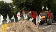 Farmers block access to the Vatry refinery on June 11, 2018 in the French department of Marne, during a demonstration called by the FNSEA farmers' union to protest plans to import palm oil for use in biofuels, a move farmers denounce as unfair competition