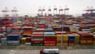 A container truck moves past containers at the Yangshan Deep Water Port in Shanghai, China April 24, 2018. (REUTERS/Aly Song/File Photo) 