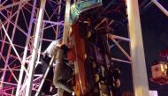 Daytona Beach firefighters are working to rescue two roller coaster riders that are in a dangling rollercoaster car when their car derailed on the Daytona Beach, Florida, boardwalk on June 14, 2018 in this Daytona Beach Fire Department photo. (Courtesy Da