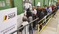 People queue to vote at a polling station during the second round of the presidential elections in Bogota, Colombia on June 17, 2018 Colombians choose a new president Sunday in a landmark election, the first since a peace agreement with FARC rebels which 