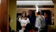 US first lady Melania Trump talks to staff and officials as she visits the Lutheran Social Services of the South 