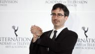File photo of comedian John Oliver posing for photographers backstage during the 41st International Emmy Awards in New York, November 25, 2013. REUTERS/Carlo Allegri
