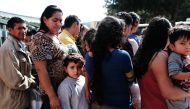 Dozens of women, men and their children, many fleeing poverty and violence in Honduras, Guatamala and El Salvador, arrive at a bus station following release from Customs and Border Protection on June 23, 2018 in McAllen, Texas.(Spencer Platt/Getty Images/