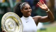 (FILES) In this file photo taken on July 09, 2016 US player Serena Williams poses with the winner's trophy, the Venus Rosewater Dish, after her women's singles final victory over Germany's Angelique Kerber on the thirteenth day of the 2016 Wimbledon Champ