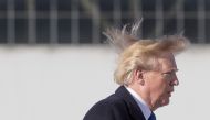 (FILES) In this file photo taken on November 10, 2017, US President Donald Trump's hair blows in the wind as he boards Air Force One before flying to Vietnam to attend the annual Asia Pacific Economic Cooperation (APEC) summit at Beijing airport. AFP / Ji