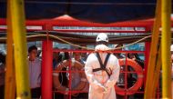 Young migrants wait on board the 