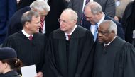 (FILES) In this file photo taken on January 20, 2017 L-R: US Chief Justice John Roberts, Justice Anthony Kennedy and Justice Clarence Thomas stand on the platform of the US Capitol in Washington, DC, before the swearing-in ceremony of US President-elect D