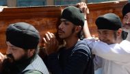 Afghan Sikhs carry the coffin of one of the 19 victims of a suicide attack in Jalalabad on July 2, 2018, a day after the attack. / AFP / NOORULLAH SHIRZADA 