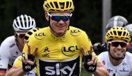 File photo of Great Britain's Christopher Froome (C) wearing the overall leader's yellow jersey flashing victory sign during the 103 km twenty-first and last stage of the 104th edition of the Tour de France cycling race, July 23, 2017. / AFP / Jeff PACHOU