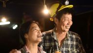 Family members celebrate while camping out near Than Luang cave following news all members of children's football team and their coach were alive in the cave at Khun Nam Nang Non Forest Park in the Mae Sai district of Chiang Rai province late July 2, 2018