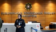 A member of the security personnel stands guard at the entrance of the Malaysian Anti-Corruption Commission (MACC) headquarters in Putrajaya, Malaysia, July 3, 2018. (REUTERS)