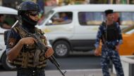 File photo of the members of the Iraqi Federal Police patroling the streets of Baghdad's Shula district, on June 29, 2018. / AFP / AHMAD AL-RUBAYE 