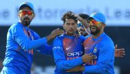 India's Kuldeep Yadav (C) celebrates after taking the wicket of England's Jos Buttler during the international Twenty20 cricket match between England and India at Old Trafford cricket ground in Manchester, northwest England, on July 3, 2018. ECB / AFP / T