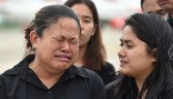 Family members grieve during arrival honors for the remains of Saman Gunan, a former Royal Thai Navy SEAL who died in an accident in Tham Luang cave in a rescue mission for the trapped 12 boys and their coach, at a military base in Chon Buri province on J