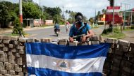 A protester stands at a barricade on the Pan-American highway during a protest against Nicaraguan President Daniel Ortega's government in Jinotepe, Nicaragua July 5, 2018.REUTERS/Oswaldo Rivas