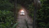 An ambulance leave the Tham Luang cave area as divers evacuated some of the 12 boys and their coach trapped at the cave in Khun Nam Nang Non Forest Park in the Mae Sai district of Chiang Rai province on July 8, 2018. (AFP / LILLIAN SUWANRUMPHA)