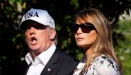 U.S. President Donald Trump talks to reporters as he walks with first lady Melania Trump on the South Lawn of the White House upon their return from Bedminster, New Jersey, to Washington, U.S., July 8, 2018. REUTERS/Yuri Gripas 