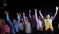 Volunteers celebrate at a makeshift press centre in Mae Sai district of Chiang Rai province on July 10, 2018, after the twelve boys and their football coach were rescued. AFP / Ye Aung Thu