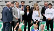 Britain's Prince Harry, Duke of Sussex (4th L) and wife Meghan, Duchess of Sussex (6th L) visit Croke Park, home of the Gaelic football association in Dublin on the final day of their two day visit on July 11, 2018. (AFP / Paul FAITH)