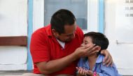 Walter Armando Jimenez Melendez, an asylum seeker from El Salvador, arrives with his four year-old son Jeremy at La Posada Providencia shelter in San Benito, Texas, U.S., shortly after he said they were reunited following separation since late May while i