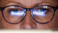 FILE PHOTO: The Facebook logo is reflected on a woman's glasses in this photo illustration taken June 3, 2018. REUTERS/Regis Duvignau/Illustration/File photo