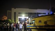 An ambulance arrives to the Heliopolis petrochemical company after a strong explosion occurred in a chemical tank near the Cairo airport late on July 12, 2018, leaving a dozen wounded. AFP / Khaled Desouki 