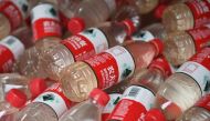 Image of polluted water that has been collected in mineral water bottles at a roving exhibition created by Chinese performance artist Nut Brother, known for his advocacy work on environmental and social issues, in Beijing, July 12, 2018.  / AFP / GREG BAK