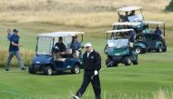 US President Donald Trump (C) walks as he plays a round of golf on the Ailsa course at Trump Turnberry, the luxury golf resort of US President Donald Trump, in Turnberry, southwest of Glasgow, Scotland on July 14, 2018, during the private part of his four